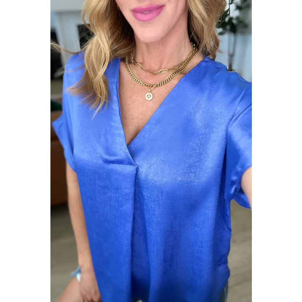 Discover effortless elegance with our Pleat Front V - Neck Top in Royal Blue! Made of luxurious satin this short sleeve