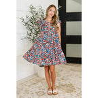 Shop the Pocket of Petals flutter sleeve mini dress in navy and coral. A flattering tiered silhouette with pockets