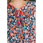 Shop the Pocket of Petals flutter sleeve mini dress in navy and coral. A flattering tiered silhouette with pockets