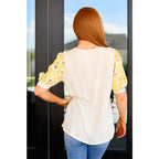 The Primrose Puff Sleeves Top blends soft ribbed knit with elegant floral puff sleeves. A chic and cute spring