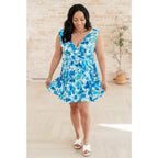 Wrinkle-resistant faux wrap dress in blue floral with built-in shorts. Soft Bulgari fabric and flattering fit. Plus