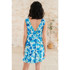 Wrinkle-resistant faux wrap dress in blue floral with built-in shorts. Soft Bulgari fabric and flattering fit. Plus