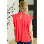 Coral flutter sleeve blouse with ruffle neckline and keyhole back. Mid-stretch knit in regular plus sizes SM-3XL. Soft