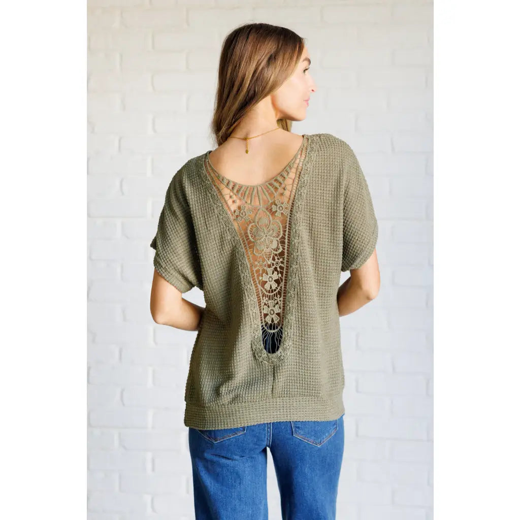Our Secret Details Lace Back Top is made from a light olive green waffle knit fabric with high stretch for ultimate