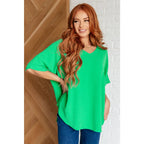 Make a statement with our Set the Expectation V-Neck Top in Green. This crinkle woven blouse features v-neck dolman