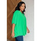 Make a statement with our Set the Expectation V-Neck Top in Green. This crinkle woven blouse features v-neck dolman