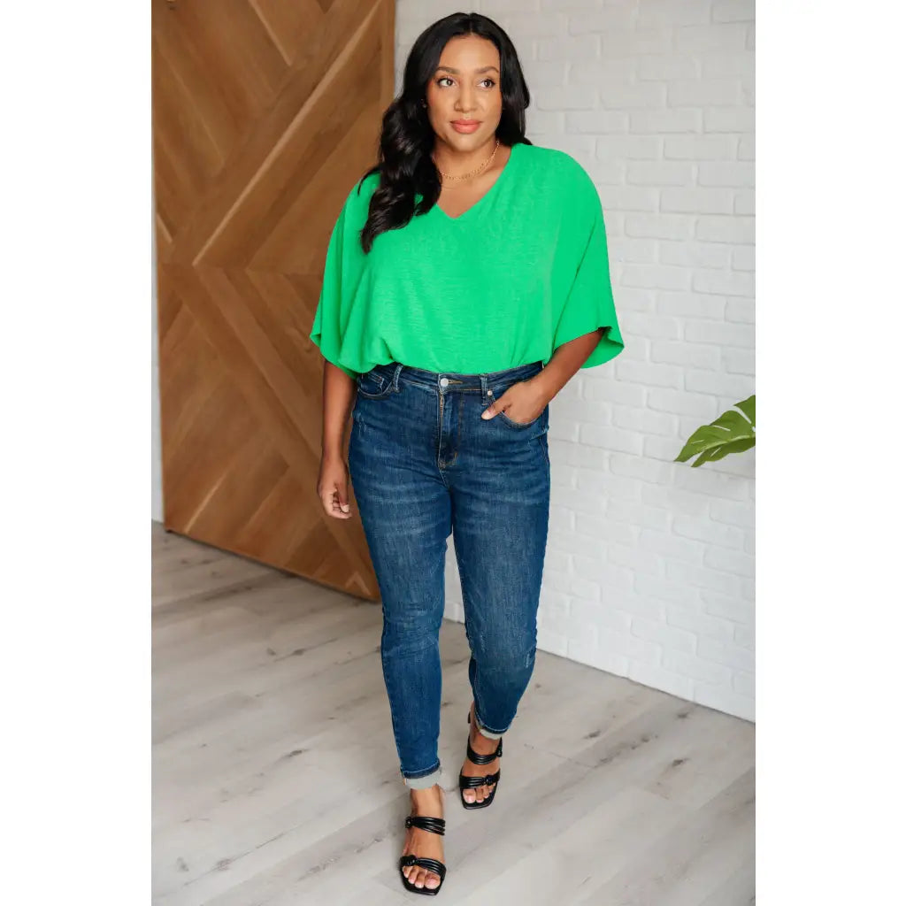 Make a statement with our Set the Expectation V-Neck Top in Green. This crinkle woven blouse features v-neck dolman