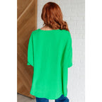 Make a statement with our Set the Expectation V-Neck Top in Green. This crinkle woven blouse features v-neck dolman