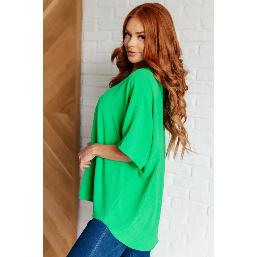 Make a statement with our Set the Expectation V Neck Top in Green. This crinkle woven blouse features v neck dolman