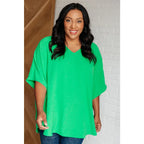 Make a statement with our Set the Expectation V-Neck Top in Green. This crinkle woven blouse features v-neck dolman