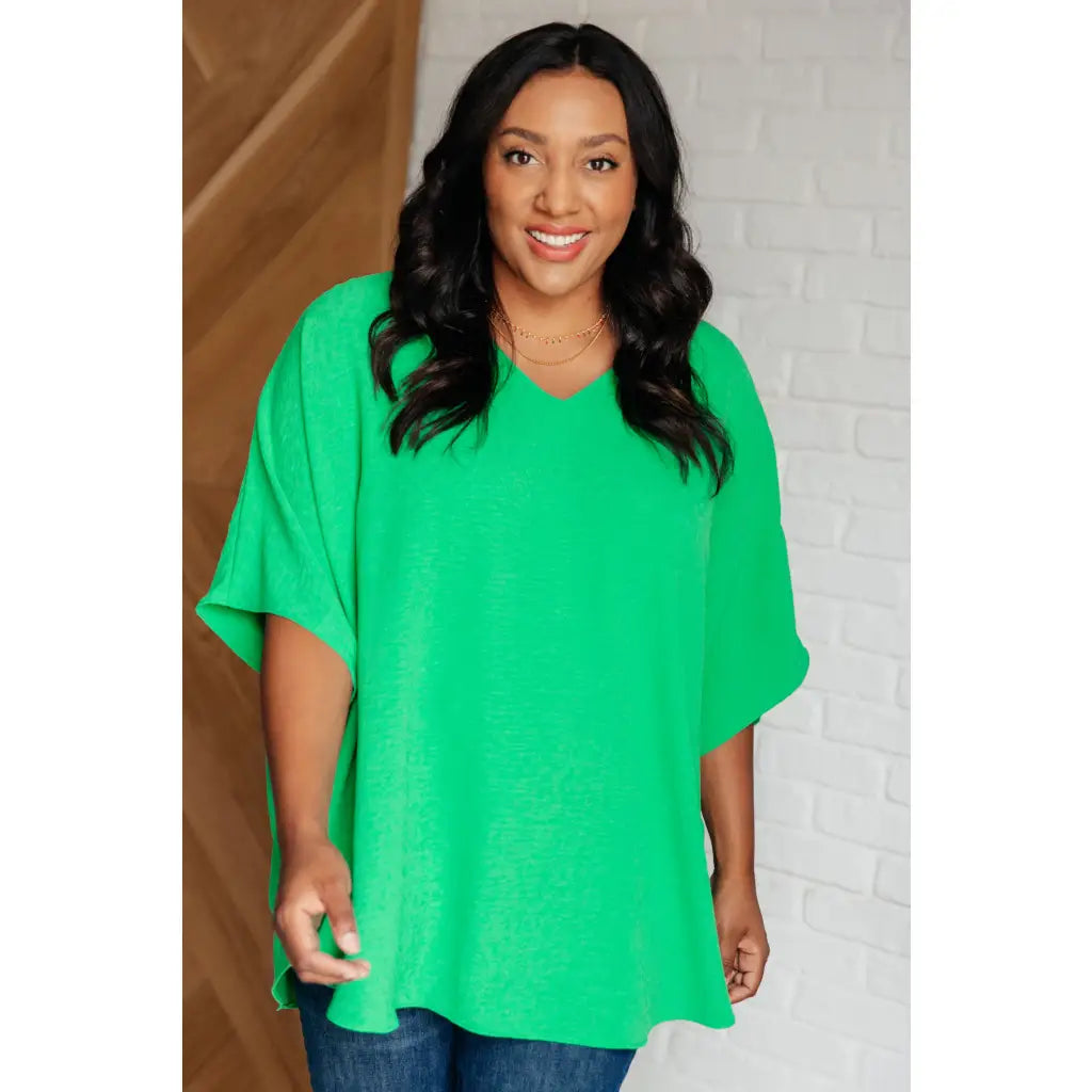 Make a statement with our Set the Expectation V-Neck Top in Green. This crinkle woven blouse features v-neck dolman