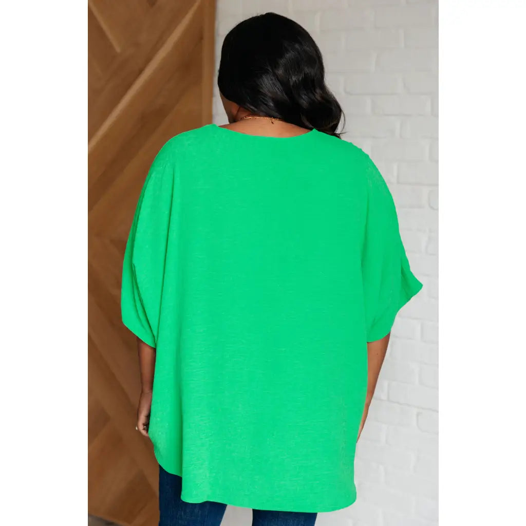 Make a statement with our Set the Expectation V-Neck Top in Green. This crinkle woven blouse features v-neck dolman