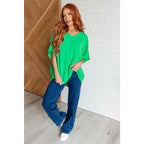 Make a statement with our Set the Expectation V-Neck Top in Green. This crinkle woven blouse features v-neck dolman