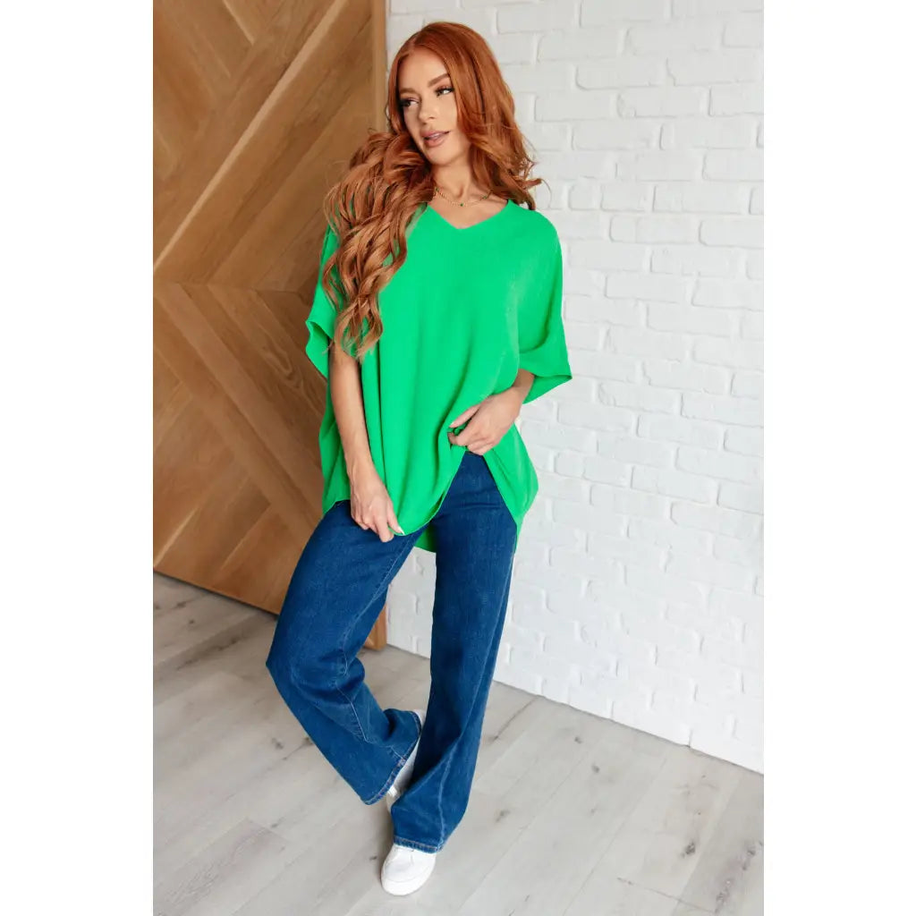 Make a statement with our Set the Expectation V-Neck Top in Green. This crinkle woven blouse features v-neck dolman