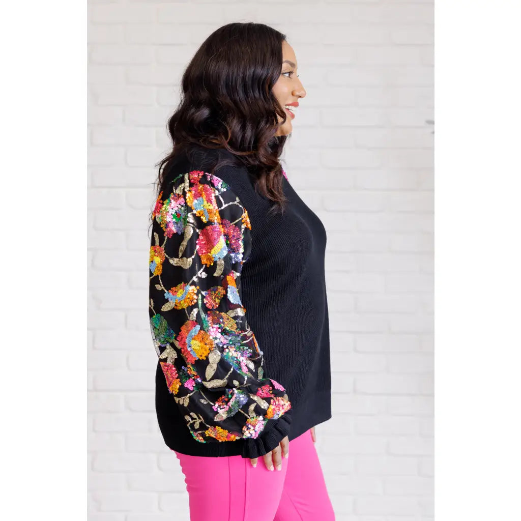 She is the Party Floral Sequins Mesh Sleeve Top brings sparkle! The black ribbed knit and banded round neckline create