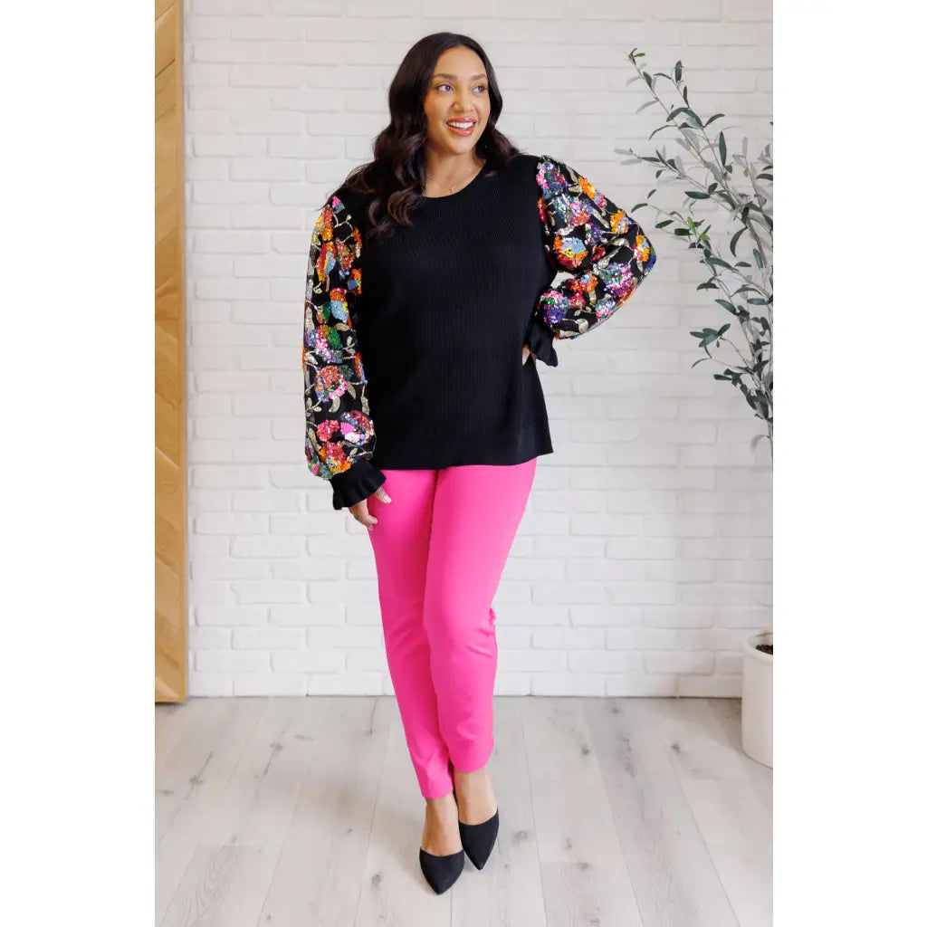 She is the Party Floral Sequins Mesh Sleeve Top brings sparkle! The black ribbed knit and banded round neckline create