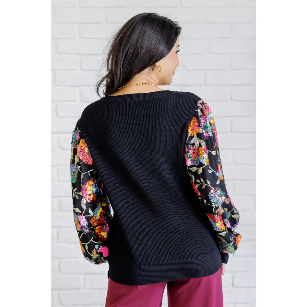 She is the Party Floral Sequins Mesh Sleeve Top brings sparkle! The black ribbed knit and banded round neckline create