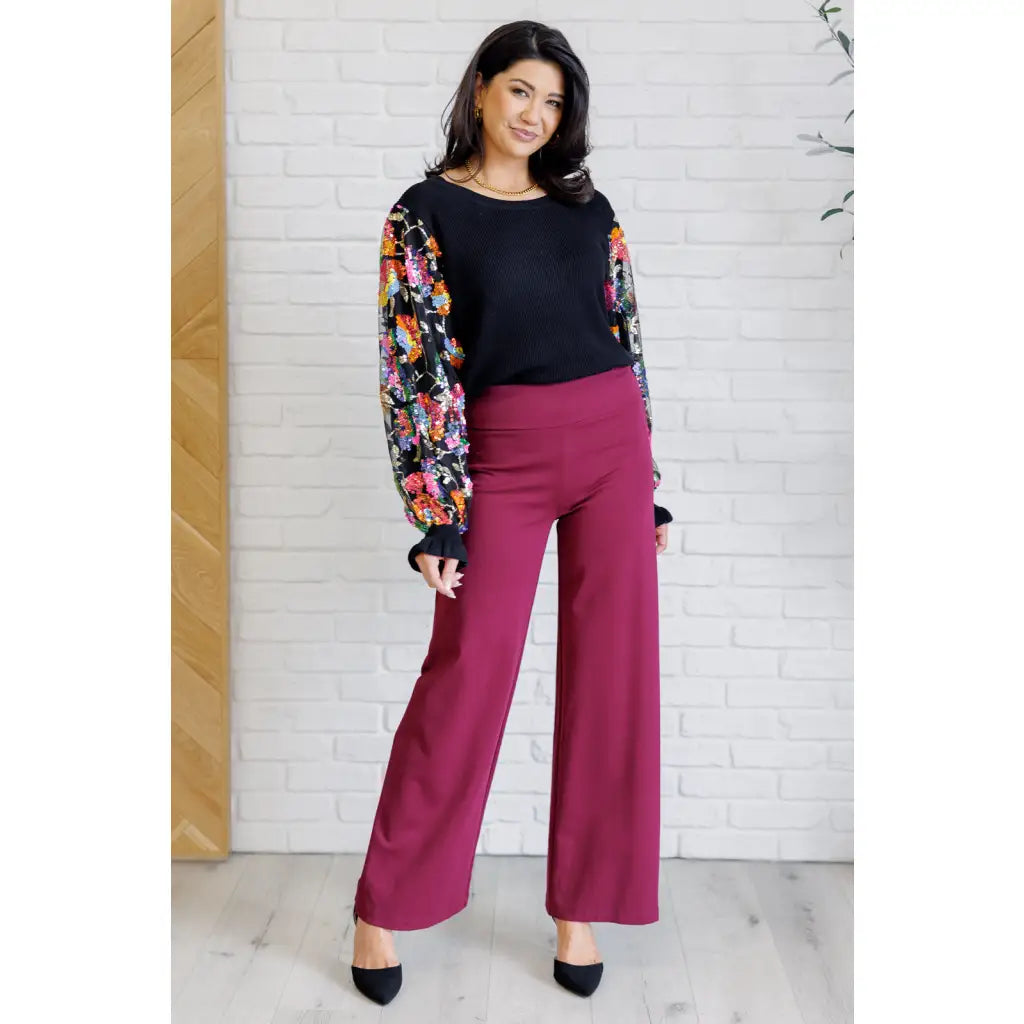 She is the Party Floral Sequins Mesh Sleeve Top brings sparkle! The black ribbed knit and banded round neckline create