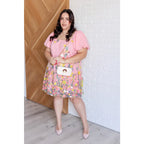 Our She’s Blooming Balloon Sleeve Mini Dress features a beautiful pink woven lining and an embroidered floral mesh