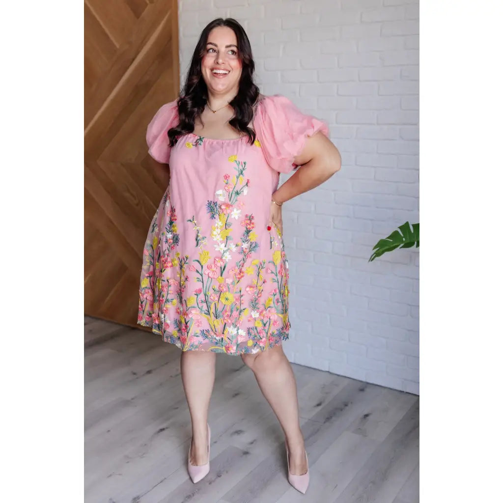 Our She’s Blooming Balloon Sleeve Mini Dress features a beautiful pink woven lining and an embroidered floral mesh