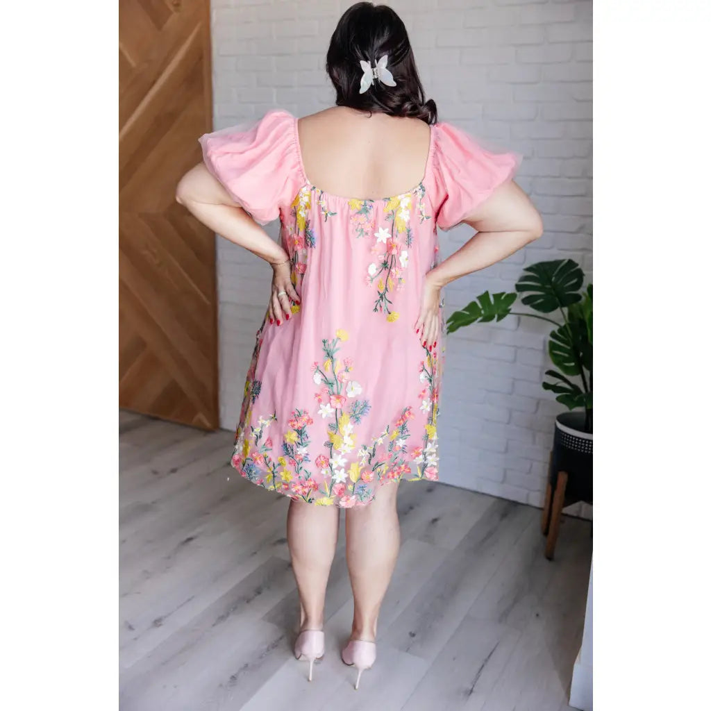 Our She’s Blooming Balloon Sleeve Mini Dress features a beautiful pink woven lining and an embroidered floral mesh