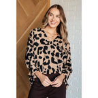 Our She’s Got Eyes of Gold Batwing Blouse is made from a soft woven material in playful animal print beige and black.
