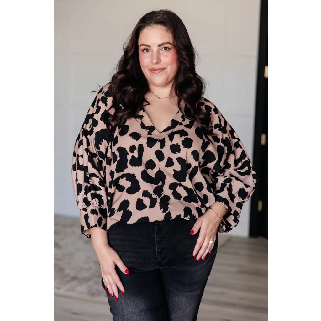 Our She’s Got Eyes of Gold Batwing Blouse is made from a soft woven material in playful animal print beige and black.