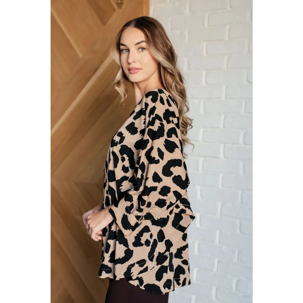 Our She’s Got Eyes of Gold Batwing Blouse is made from a soft woven material in playful animal print beige and black.