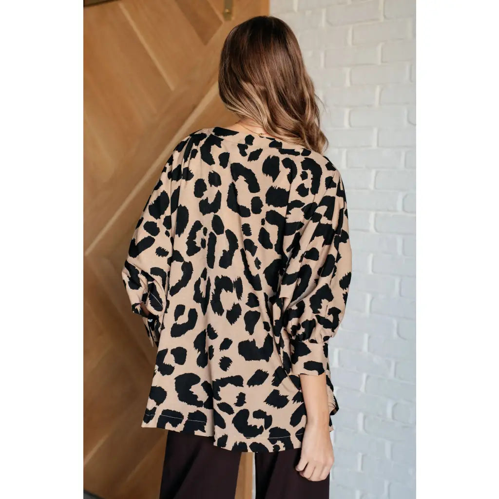 Our She’s Got Eyes of Gold Batwing Blouse is made from a soft woven material in playful animal print beige and black.