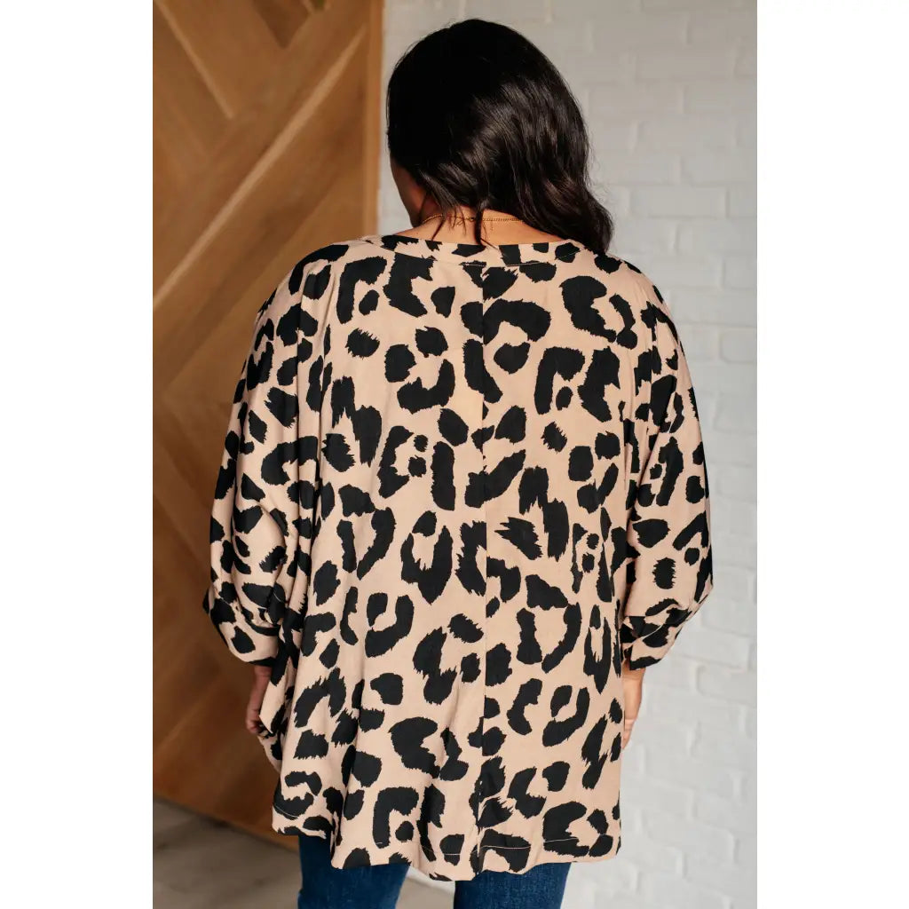 Our She’s Got Eyes of Gold Batwing Blouse is made from a soft woven material in playful animal print beige and black.