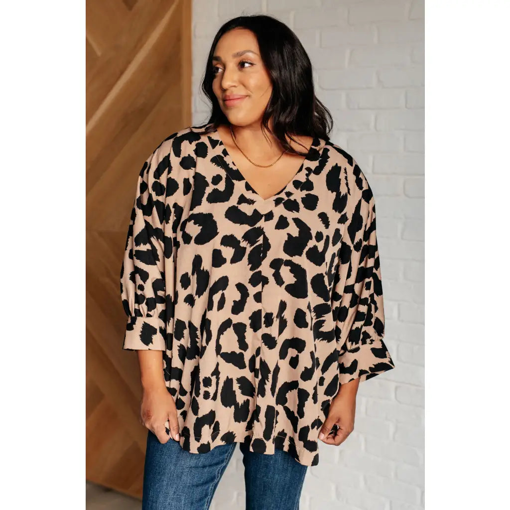 Our She’s Got Eyes of Gold Batwing Blouse is made from a soft woven material in playful animal print beige and black.