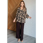 Our She’s Got Eyes of Gold Batwing Blouse is made from a soft woven material in playful animal print beige and black.