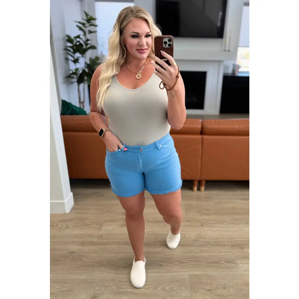 Mid rise Judy Blue shorts with raw hem and stretch. Flattering fit for standard curvy plus sizes. Spring summer denim