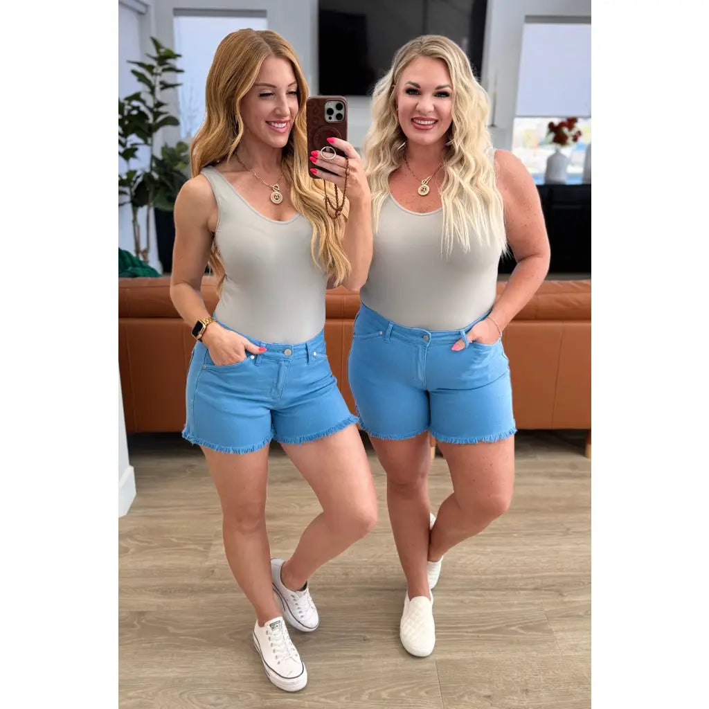 Mid rise Judy Blue shorts with raw hem and stretch. Flattering fit for standard curvy plus sizes. Spring summer denim