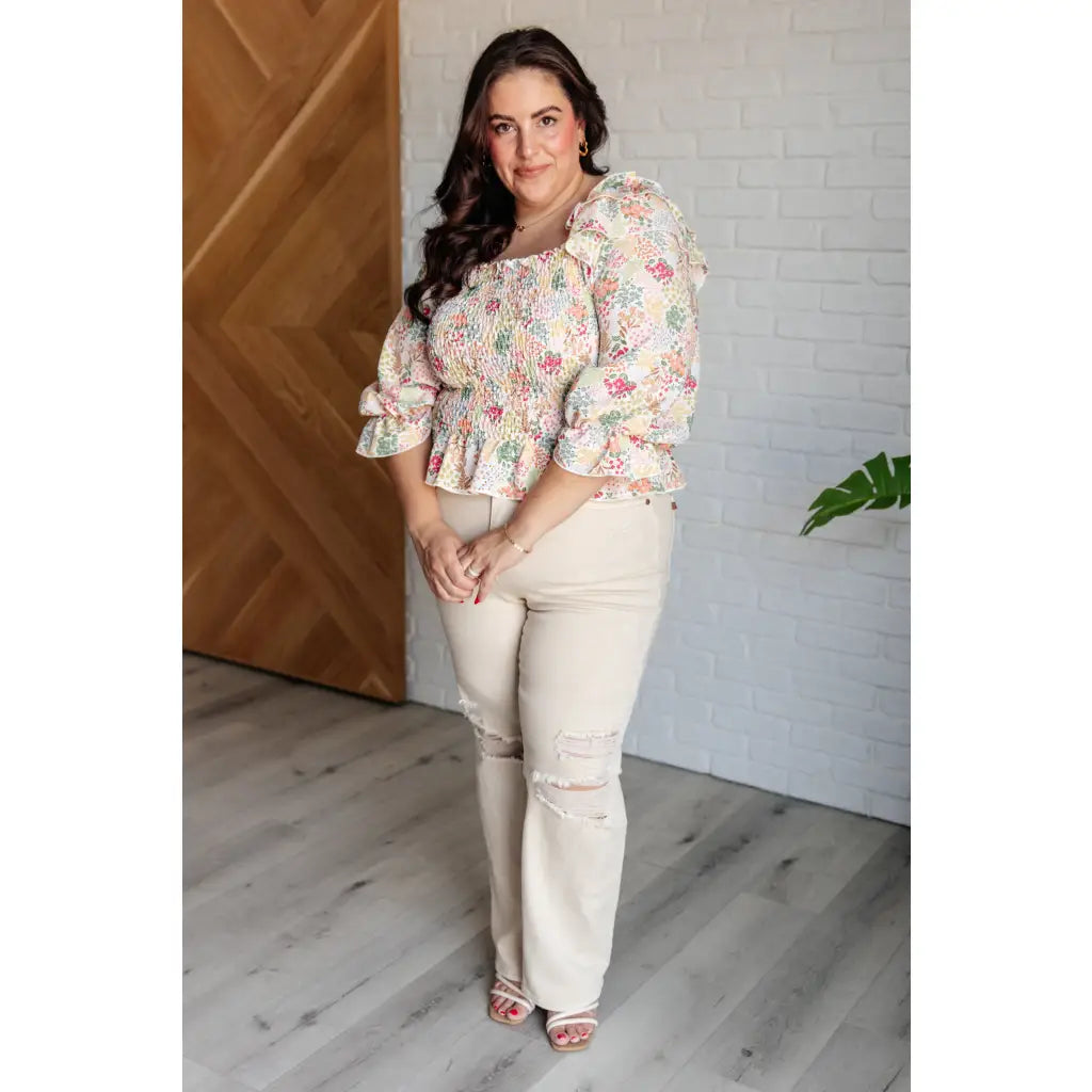 Our Social Season Floral Smocked Blouse is made from crinkle woven fabric. It features a smocked elastic bodice