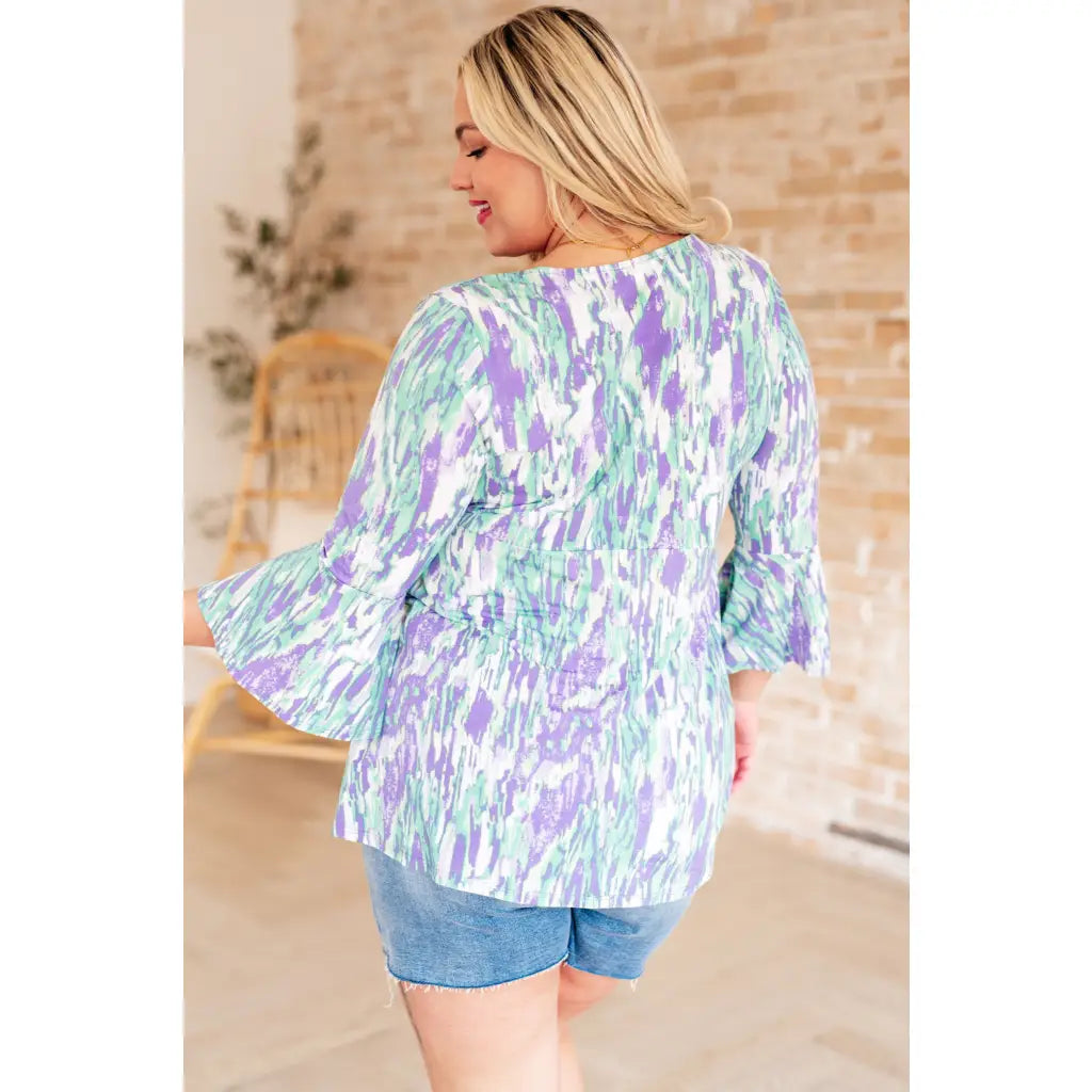 Shop the Spring into Action Bell Sleeve Top in mint and lavender abstract print. Wrinkle resistant flowy