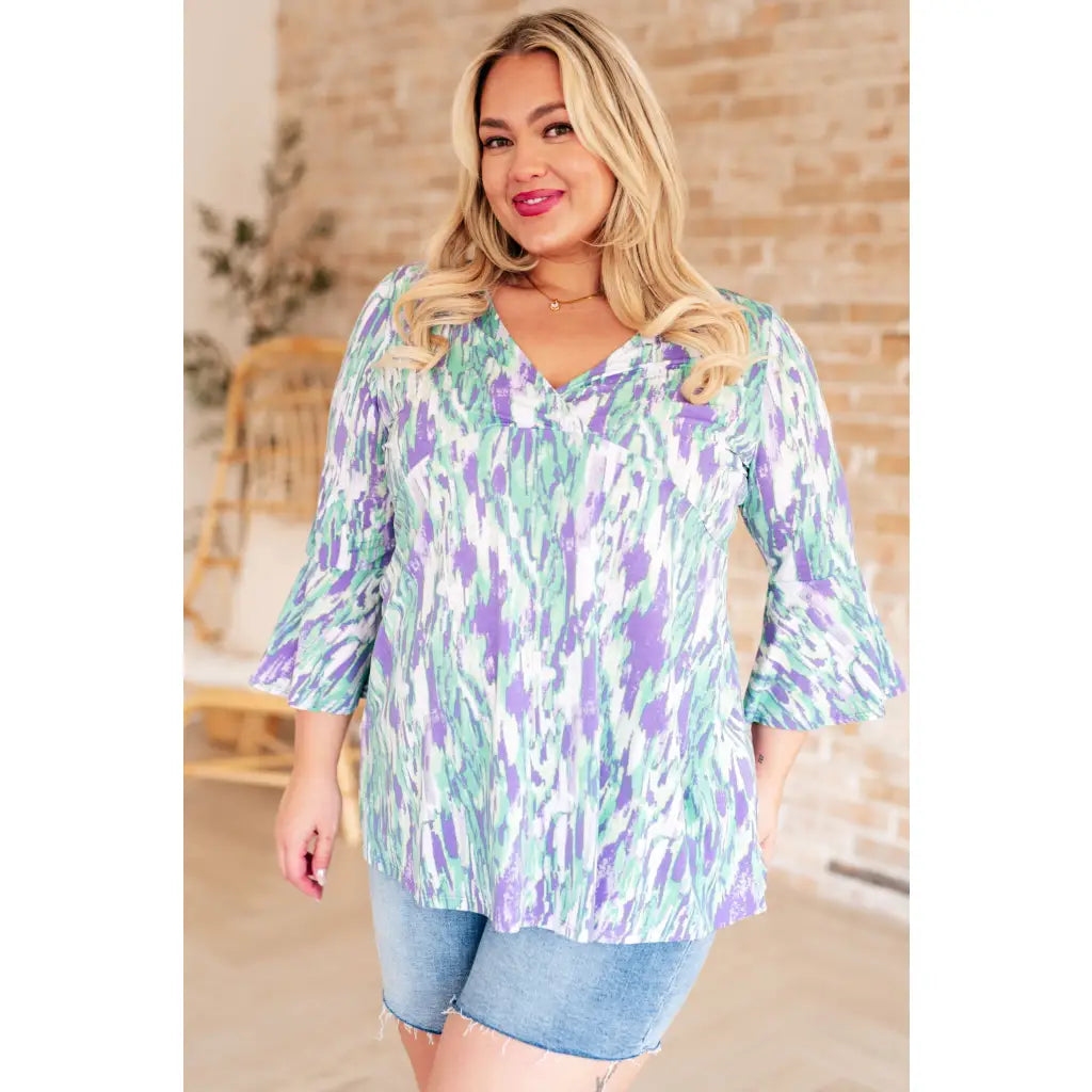 Shop the Spring into Action Bell Sleeve Top in mint and lavender abstract print. Wrinkle resistant flowy