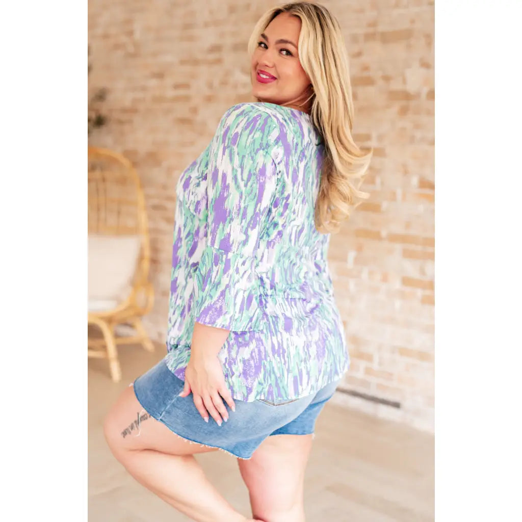 Shop the Spring into Action Bell Sleeve Top in mint and lavender abstract print. Wrinkle resistant flowy