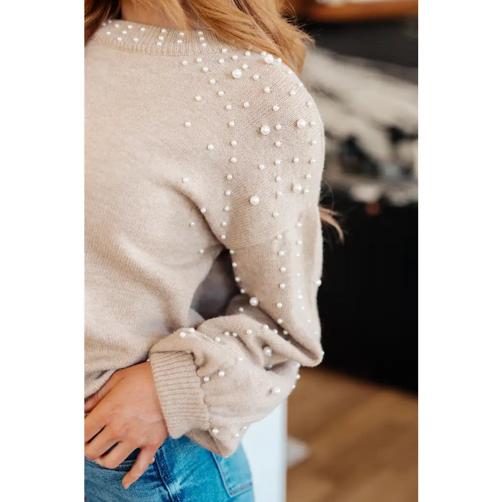 Stay stylish and cozy with our String Me Along Pearl Accent Beige Sweater. Made from lightweight knit this sweater