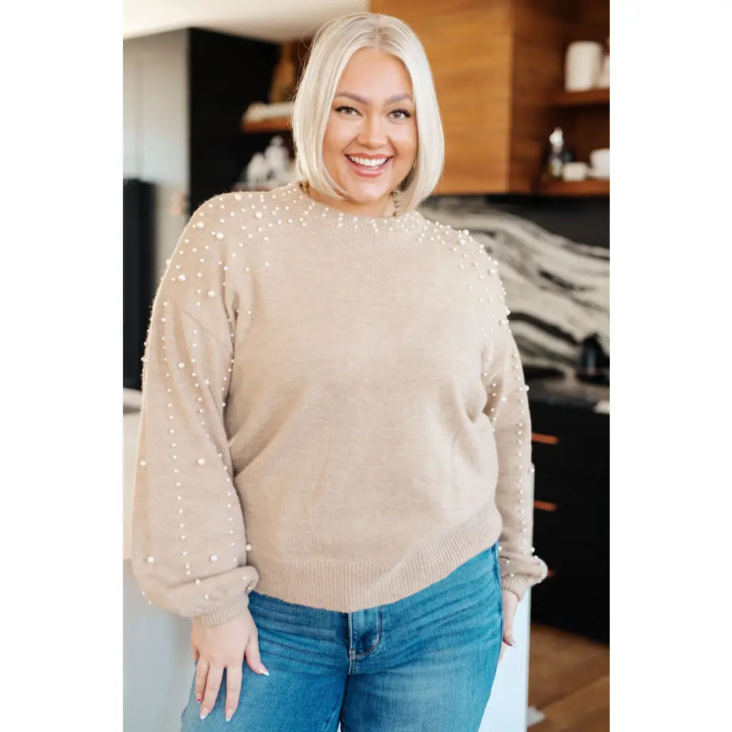Stay stylish and cozy with our String Me Along Pearl Accent Beige Sweater. Made from lightweight knit this sweater