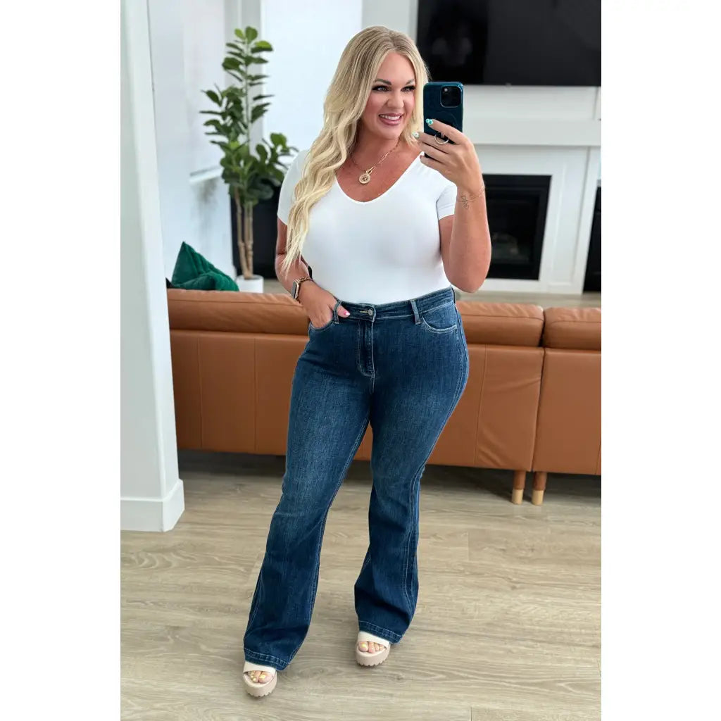 Our Sweet Side Seams Flare Judy Blue Jean are high rise non-distressed jeans feature a dark wash and unique offset side