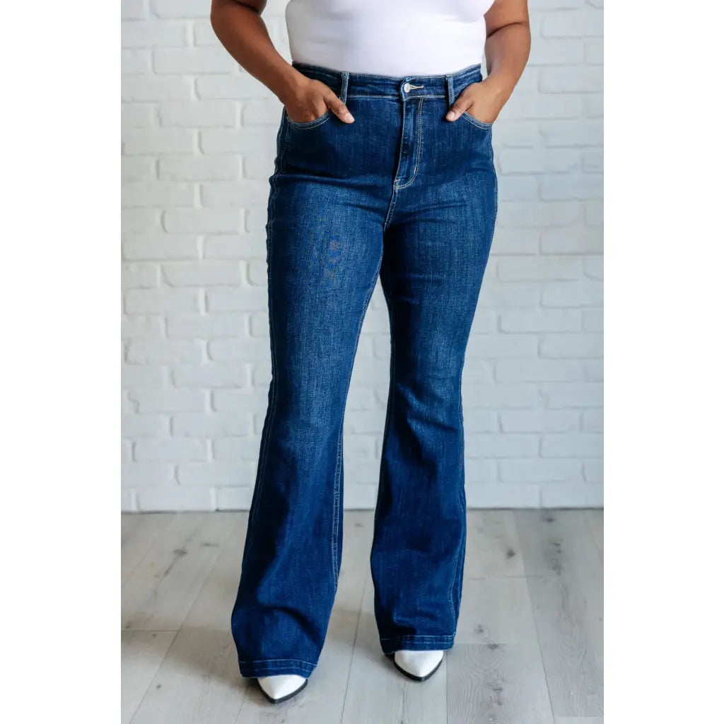 Our Sweet Side Seams Flare Judy Blue Jean are high rise non-distressed jeans feature a dark wash and unique offset side