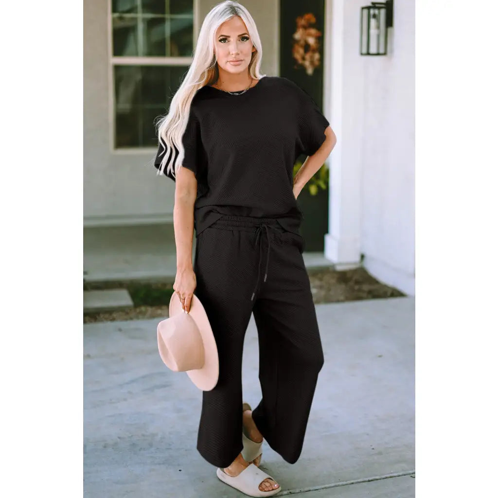 Our Textured Bae Short Sleeve Top and Pants Set is anything but basic. Featuring a drawstring wide leg cropped pant