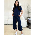 Our Textured Bae Short Sleeve Top and Pants Set is anything but basic. Featuring a drawstring wide leg cropped pant