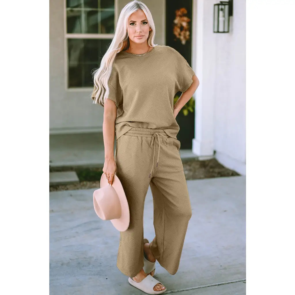 Our Textured Bae Short Sleeve Top and Pants Set is anything but basic. Featuring a drawstring wide leg cropped pant