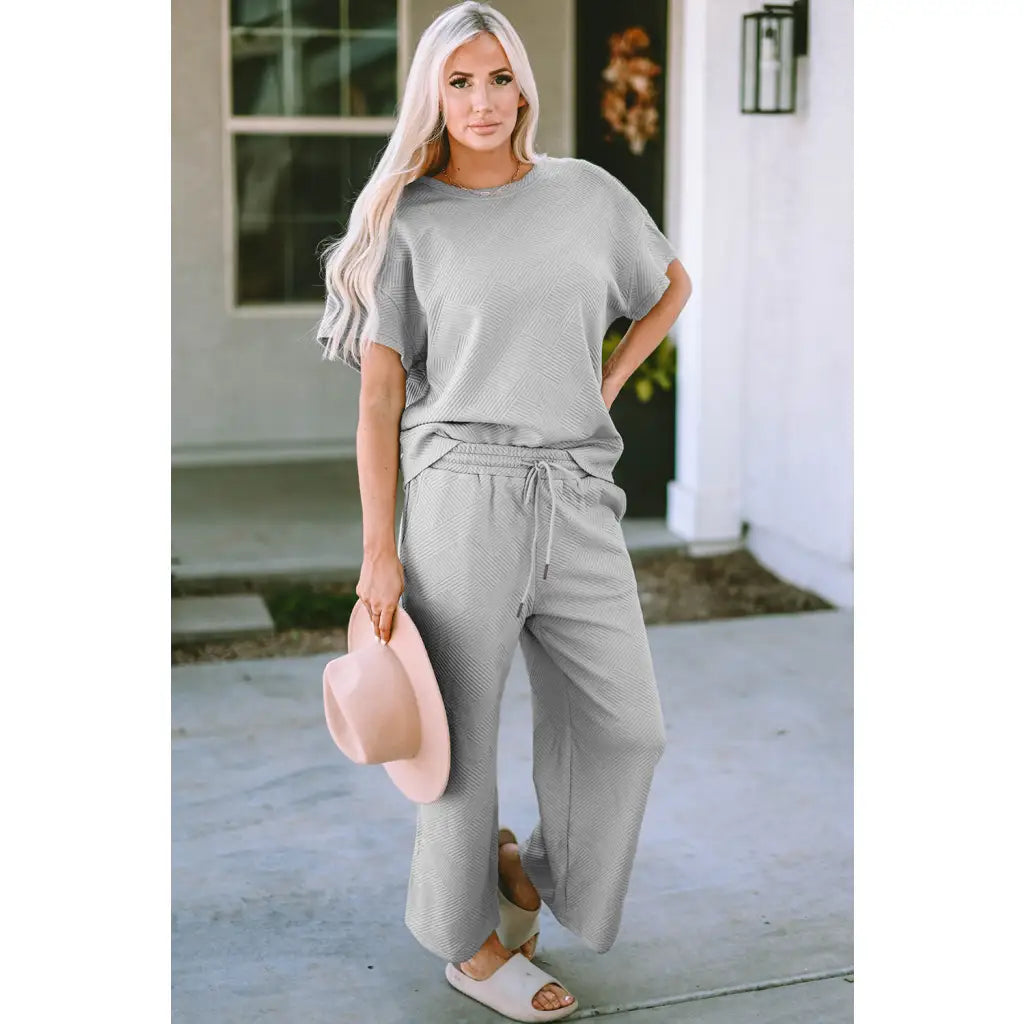 Our Textured Bae Short Sleeve Top and Pants Set is anything but basic. Featuring a drawstring wide leg cropped pant