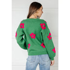 Stay cozy in The Bloom Sweater! A soft ribbed knit pullover with tufted pink flowers balloon sleeves and a relaxed fit.