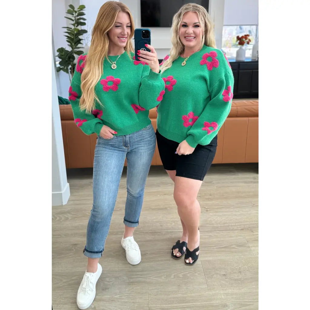 Stay cozy in The Bloom Sweater! A soft ribbed knit pullover with tufted pink flowers balloon sleeves and a relaxed fit.