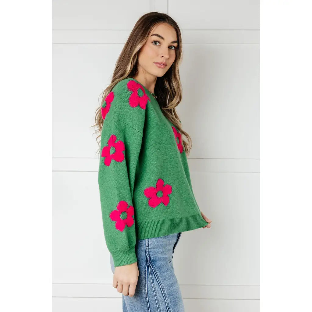 Stay cozy in The Bloom Sweater! A soft ribbed knit pullover with tufted pink flowers balloon sleeves and a relaxed fit.