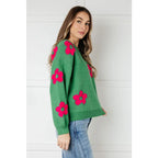 Stay cozy in The Bloom Sweater! A soft ribbed knit pullover with tufted pink flowers balloon sleeves and a relaxed fit.